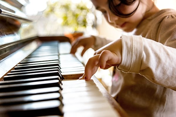 preschool music program girl on piano