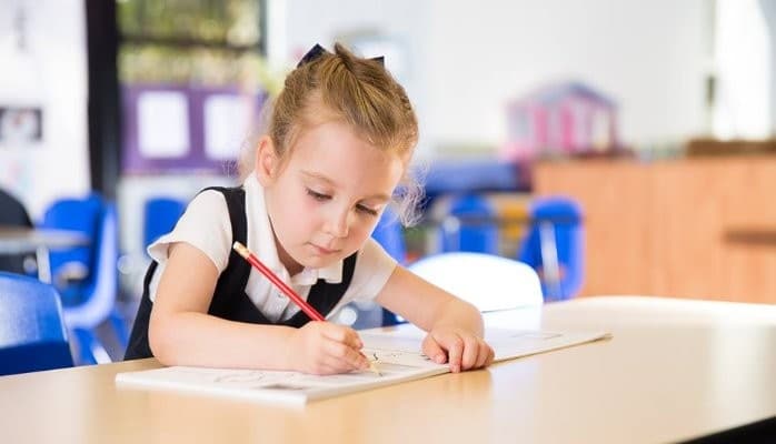 preschool prekindergarten girl writing with pencil